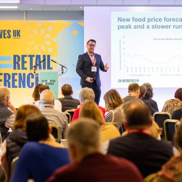 Presenter speaking on state at Co-operative Retail Conference