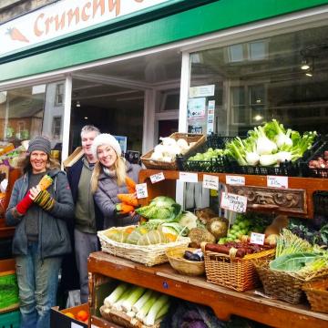 Group of people stood outside a greengrocers