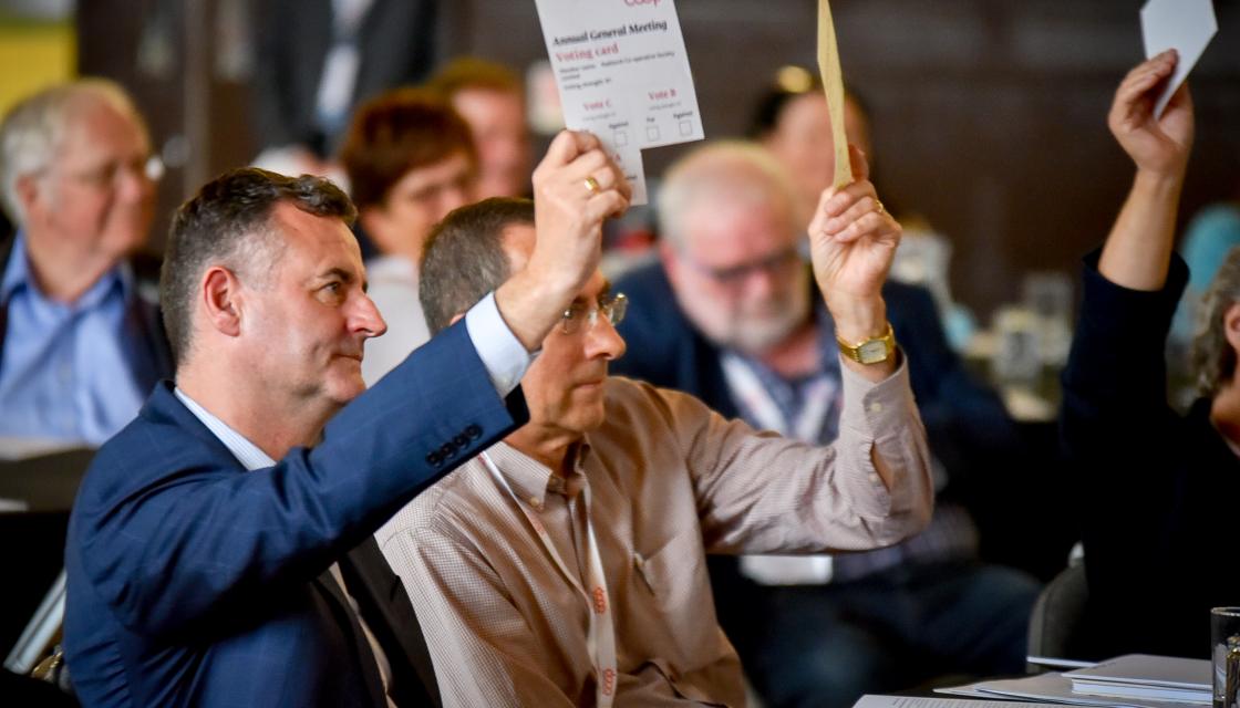 Man holding voting paper