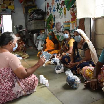 Group of Indian women sharing information about Covid symptoms