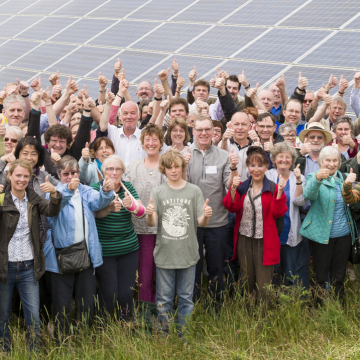 Large group of members in front of solar panels